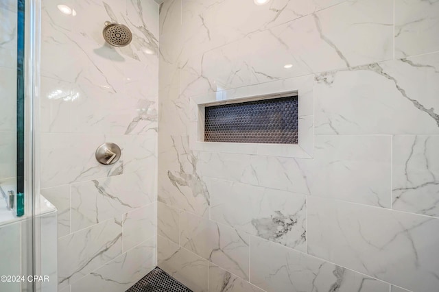 bathroom with wood-type flooring, vanity, and a shower with shower door