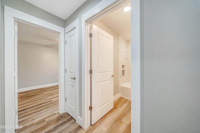 unfurnished bedroom featuring light wood-type flooring, ceiling fan, and lofted ceiling