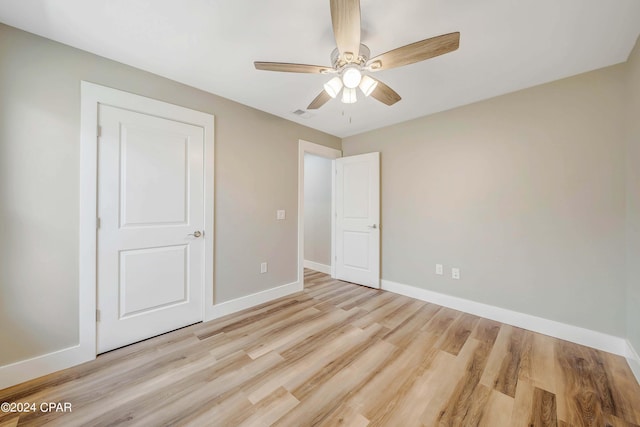 unfurnished bedroom with ceiling fan and light hardwood / wood-style floors