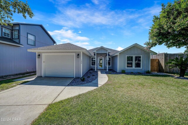 single story home featuring a front yard and a garage