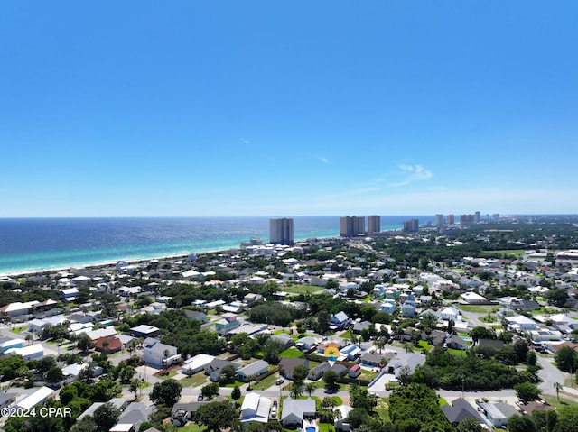 birds eye view of property with a water view and a beach view