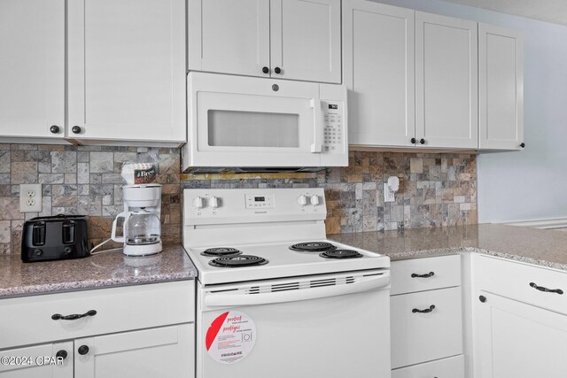 kitchen featuring decorative backsplash, white cabinets, and white appliances