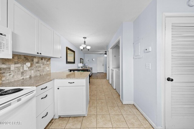 kitchen featuring white cabinets, light tile patterned floors, decorative light fixtures, and light stone counters