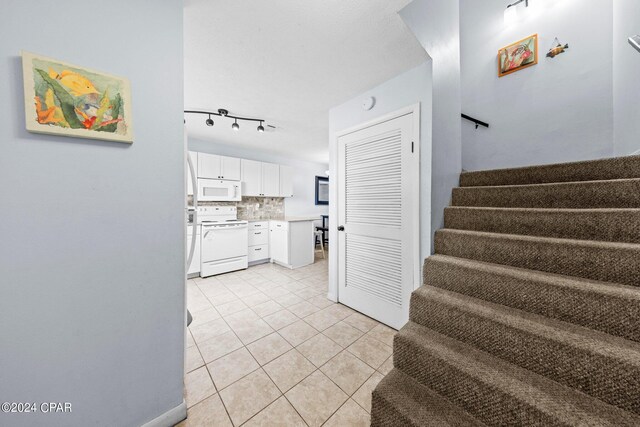 stairs with tile patterned floors