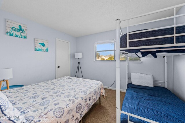 bedroom with carpet and a textured ceiling