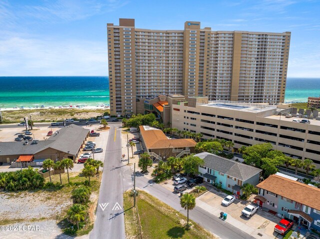 drone / aerial view with a water view and a beach view