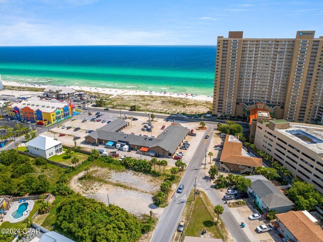 drone / aerial view with a water view and a beach view