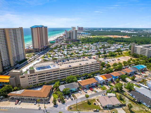 drone / aerial view featuring a beach view and a water view