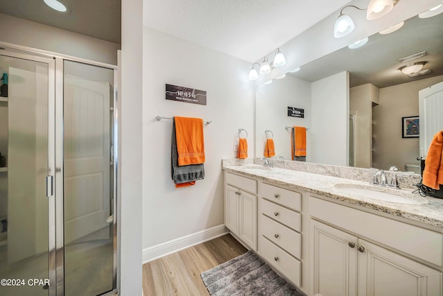 bathroom with vanity, hardwood / wood-style flooring, and an enclosed shower