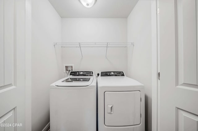 clothes washing area with washer and dryer