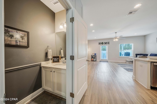 bathroom featuring ceiling fan, vanity, and wood-type flooring