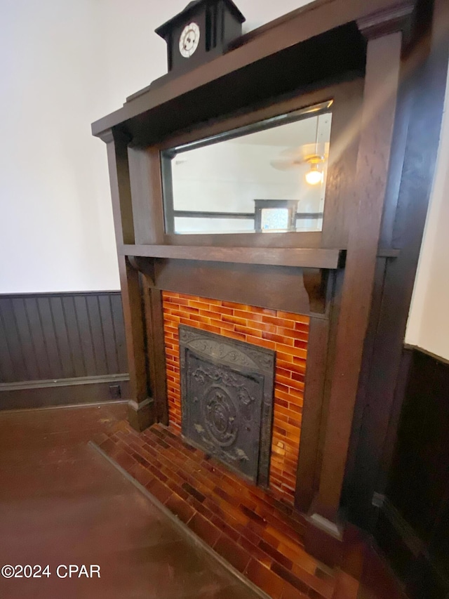 room details with a fireplace and ceiling fan