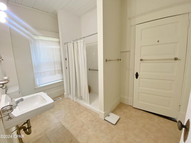 bathroom with tile floors, sink, and toilet