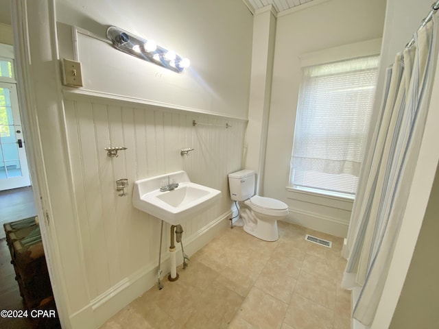 bathroom featuring tile floors, sink, and toilet