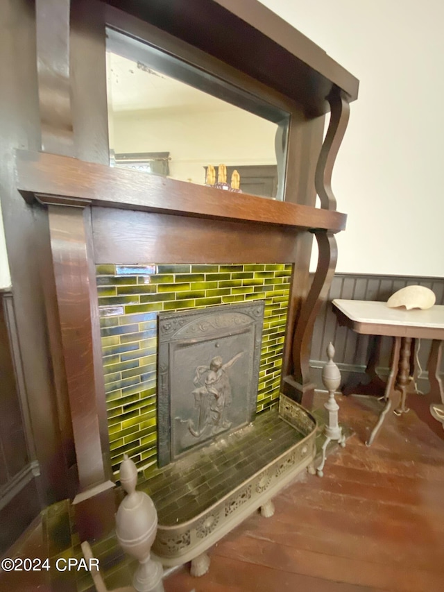 details featuring a tile fireplace and wood-type flooring