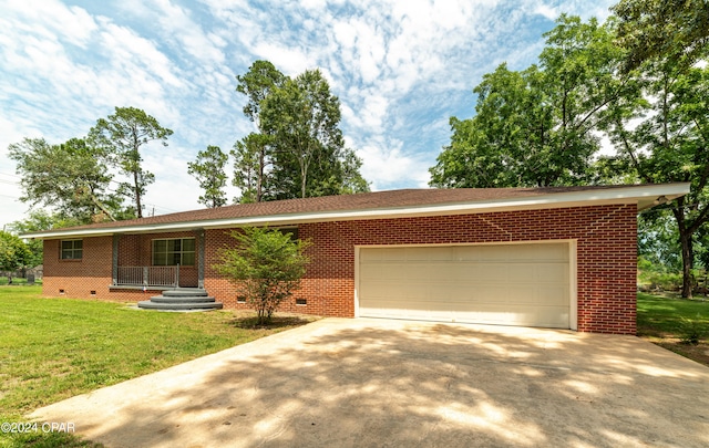 ranch-style house with a garage and a front yard