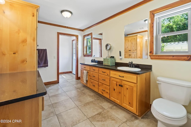 bathroom with tile flooring, crown molding, toilet, and vanity