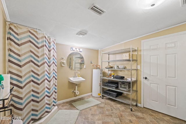 bathroom featuring sink, water heater, tile flooring, and ornamental molding