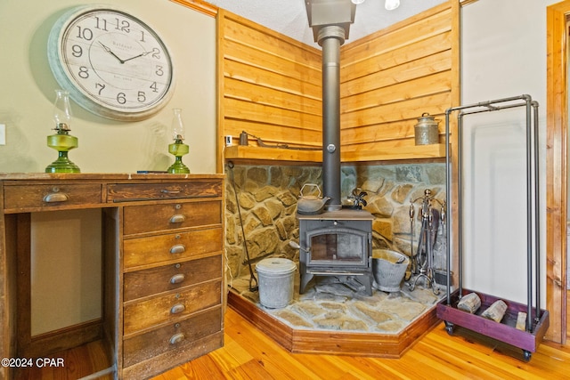 living room featuring hardwood / wood-style flooring and a wood stove