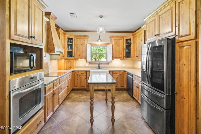 kitchen featuring tile flooring, custom exhaust hood, decorative light fixtures, black appliances, and sink