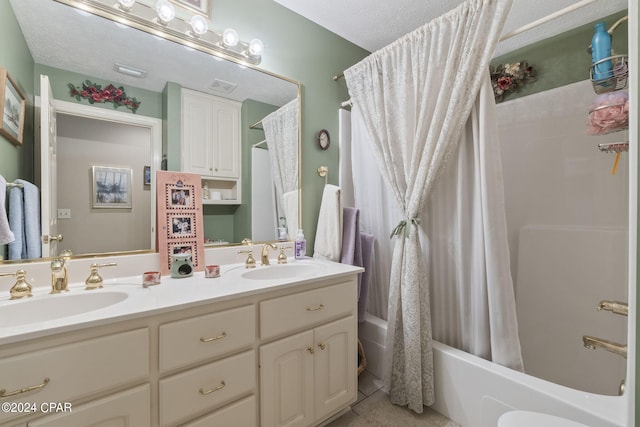 full bathroom with shower / bath combo, tile patterned flooring, a textured ceiling, toilet, and vanity