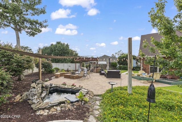 view of yard featuring a patio and an outdoor living space with a fire pit