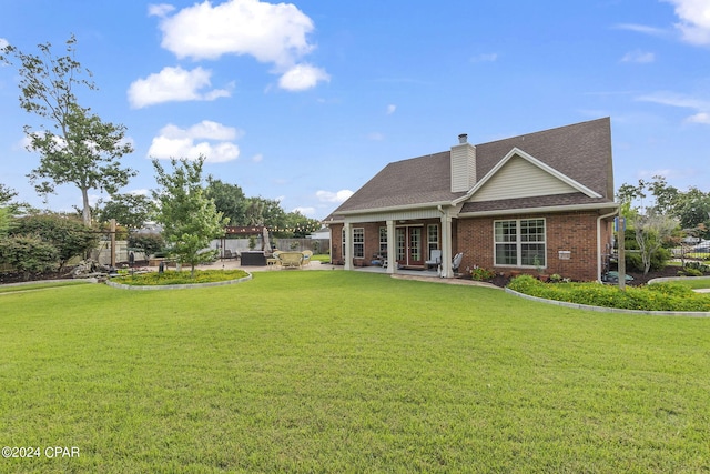 view of front of house featuring a patio and a front yard