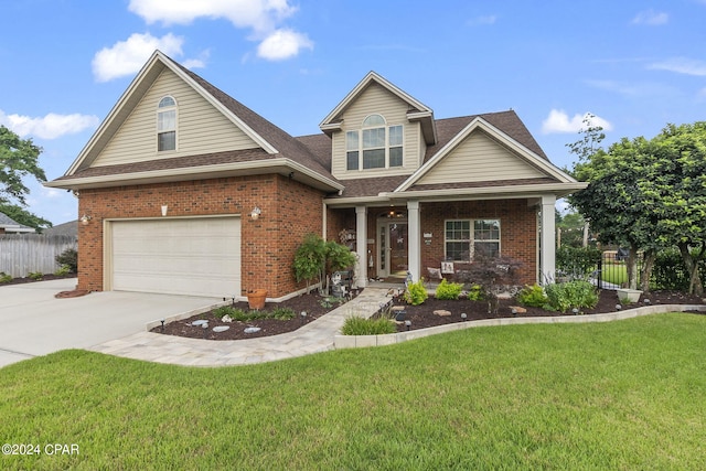 craftsman inspired home with a porch, a front yard, and a garage