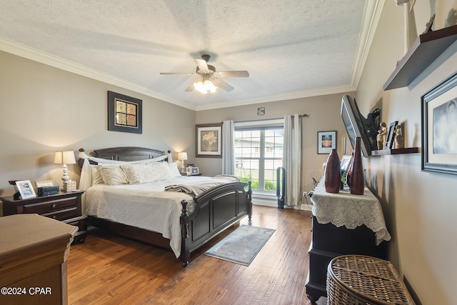 bedroom with dark hardwood / wood-style flooring, a textured ceiling, ceiling fan, and crown molding