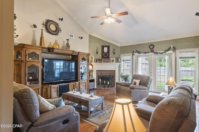 living room with ceiling fan, crown molding, a fireplace, hardwood / wood-style floors, and lofted ceiling