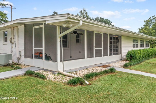 exterior space with a sunroom and a yard