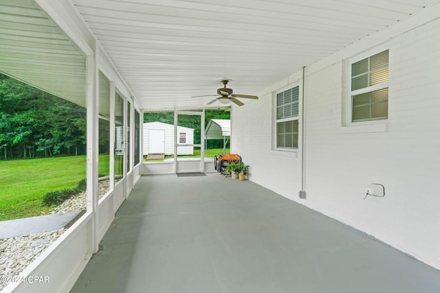 view of patio / terrace with a shed and ceiling fan