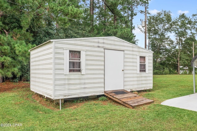 view of outbuilding with a lawn