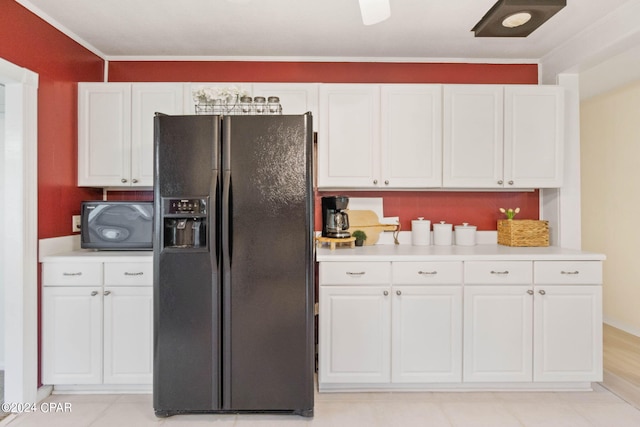 kitchen with white cabinets, crown molding, black fridge with ice dispenser, and light tile patterned floors