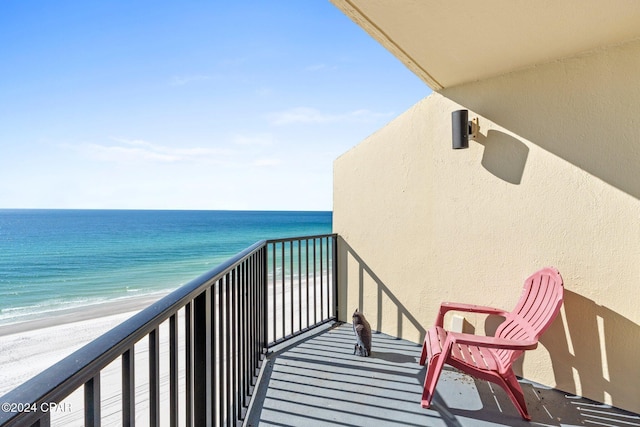 balcony with a water view and a beach view