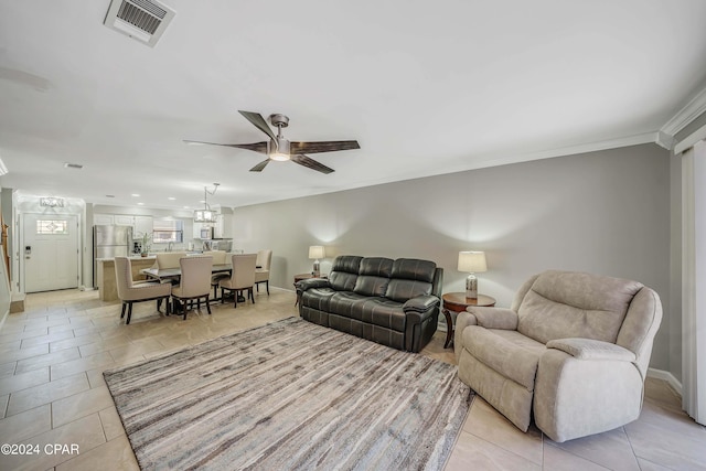 living room featuring ceiling fan, ornamental molding, and light tile patterned flooring