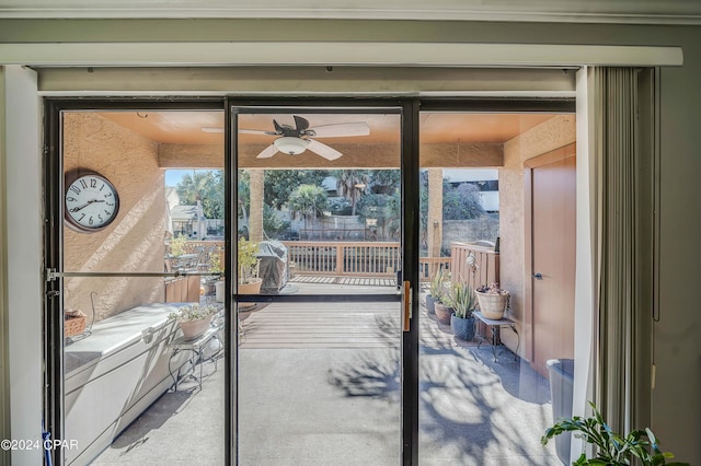 doorway to outside featuring ceiling fan