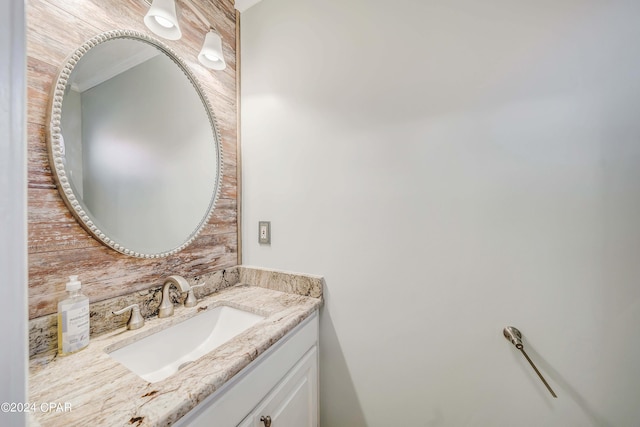 bathroom with vanity and ornamental molding