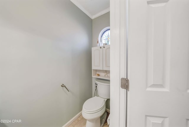 bathroom featuring tile patterned flooring, toilet, and ornamental molding