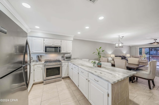 kitchen featuring decorative backsplash, white cabinetry, kitchen peninsula, and appliances with stainless steel finishes