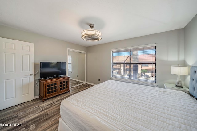 bedroom with dark hardwood / wood-style floors