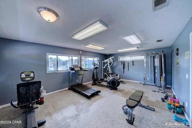 workout room featuring a textured ceiling