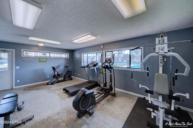 exercise room with a textured ceiling