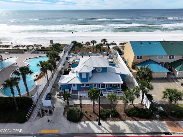 aerial view with a water view and a beach view