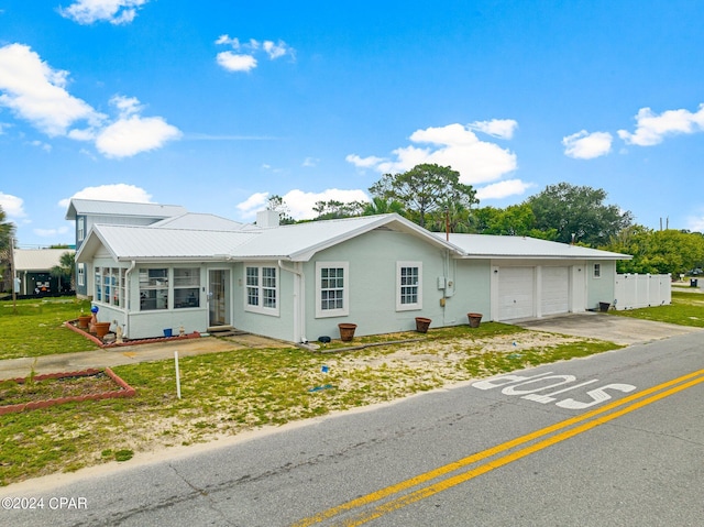 ranch-style house with a garage and a front lawn