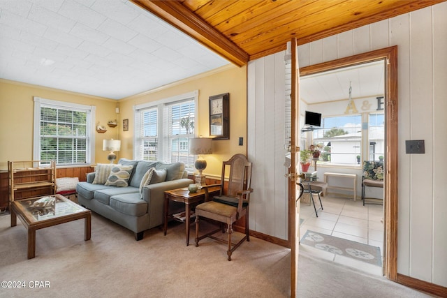 carpeted living room with wood ceiling, crown molding, and wood walls