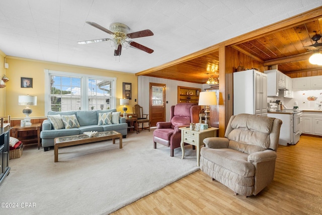 living room featuring wood walls, wooden ceiling, ceiling fan, light hardwood / wood-style flooring, and ornamental molding