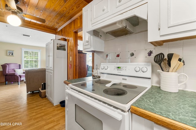 kitchen with light wood-type flooring, white cabinets, backsplash, ceiling fan, and white electric range