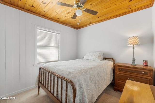 carpeted bedroom with wood ceiling, ceiling fan, and ornamental molding