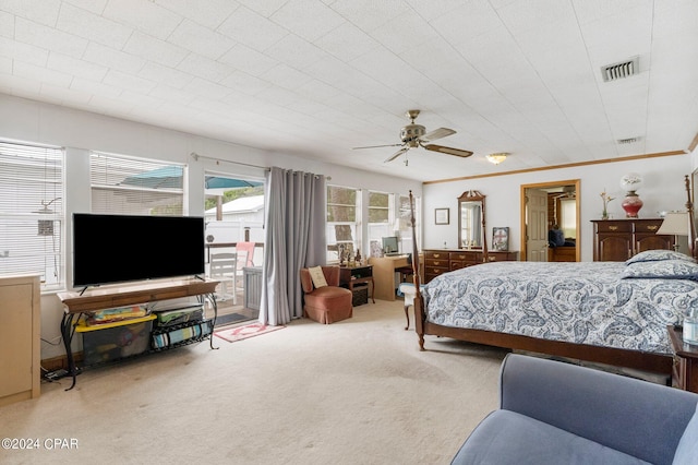 bedroom featuring ceiling fan, ornamental molding, and carpet